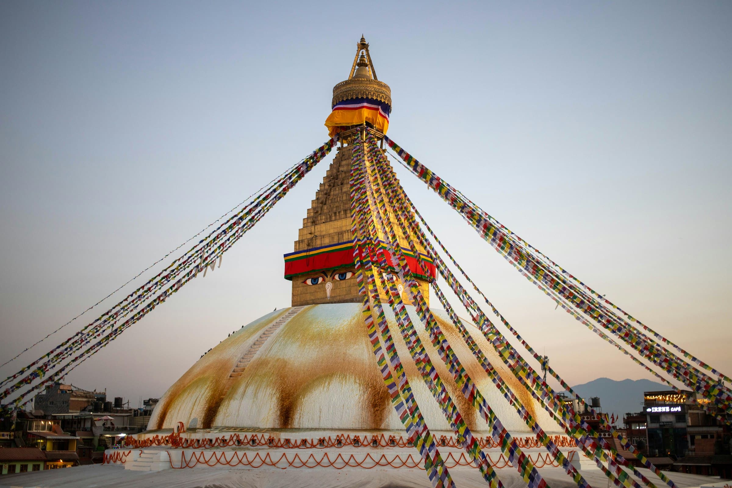 Prayer flags radiating from Boudhanath Stupa in Kathmandu at dusk
